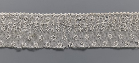 Lace fragment, needle lace Alençon lace, A flower branch parallel to the edge. Above the branch, in