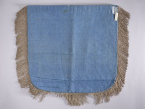 A hood from a church cope. The cope hood is made of pale green velvet. In the center, two
