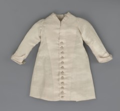 Children's dress made of cream satin. Long, fitted at the top, slightly flared at the bottom.