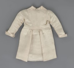 Children's dress made of cream satin. Long, fitted at the top, slightly flared at the bottom.