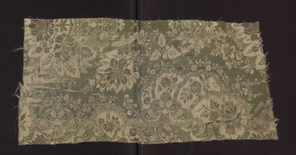 Fabric fragment, early 18th century, France. Silk fabric with preserved patterned and lace-like