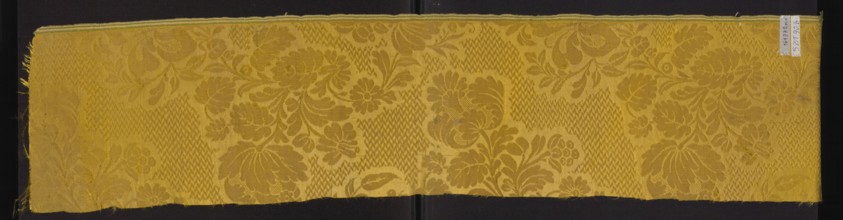 Fabric fragment, silk damask fragment, patterned floral motifs, preserved selvedge. Yellow damask