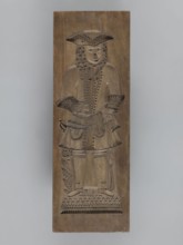 Double-sided gingerbread mould. Side A: image of a bachelor; Side B: baby in swaddling clothes.,