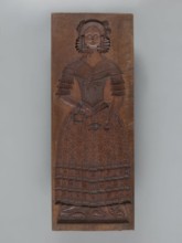 Double-sided gingerbread mould. Side A: female figure in a decorative bonnet and long patterned