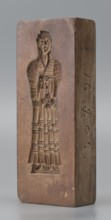 Double-sided gingerbread mould. Side A: figure of a lady in a decorative, pleated early