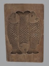 Double-sided gingerbread mould. Obverse: group of musicians; reverse: three fish. Double-sided,