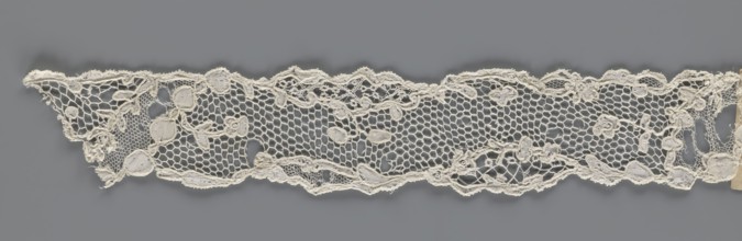 Lace fragment, mid-18th century, France. Lace with an ornament carried on two edges and a free