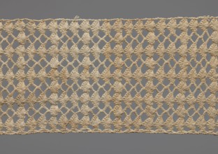 Fragment of crocheted lace, section of a belt, cream-colored, with motifs of semicircular shells