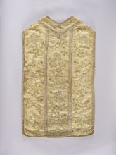 Chasuble, liturgical vestment. White chasuble covered with colorful and silver embroidery in a