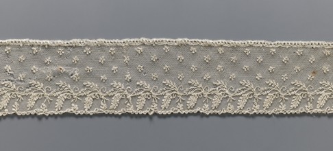 Fragment of lace, Alençon lace, decorated with small twigs in projections and a tendril with