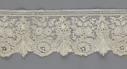 Lace fragment;, purchased provenance noted; lace with plant ornaments. Serrated on one side, with a
