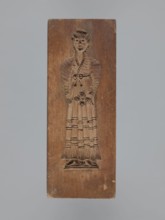 Double-sided gingerbread mould. Obverse: female figure in a long, patterned, richly decorated