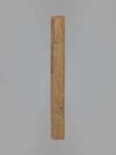Double-sided gingerbread form. Obverse: female figure in a long patterned dress wearing a hat.
