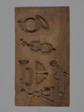 Double-sided gingerbread form. Obverse: four representations — two richly decorated oriental pipes