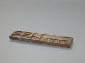 Double-sided gingerbread mould. Obverse: images of four heads; depending on rotation the heads take