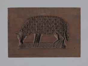 Double-sided gingerbread form; rectangular shape. One side: image of a sheep grazing in a meadow.