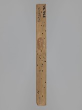 Double-sided gingerbread mold; obverse: female figure in a hat and long patterned dress; reverse: