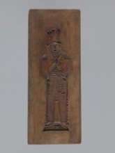 Double-sided gingerbread mould. Side A: figure of a soldier; Side B: various floral and geometric