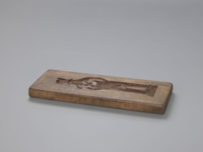 Double-sided gingerbread mould. Side A: figure of a soldier. Side B: various floral and geometric