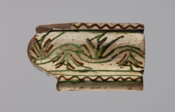 Cornice tile fragments 4, painted with a wavy twirl pattern; tile cullet; stoves; plant