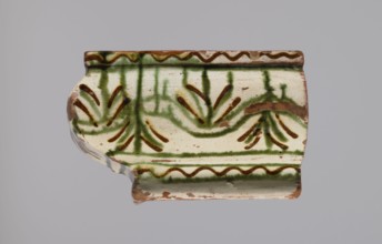 Cornice tile fragments 4, painted with a wavy twirl pattern; tile cullet; stoves; plant