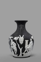 Pelike-shaped vase, black with white reliefs rendered from a black background depicting: 1 Atia,