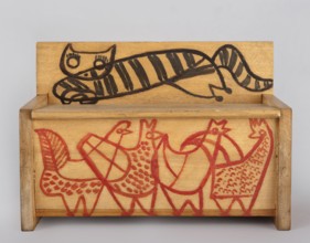 A wooden bench from a set of doll furniture. Wooden bench with a box closed by a flap forming a