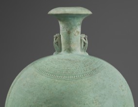 Flat round faience canteen with a narrow short neck ending in a chipped spout shaped like a papyrus