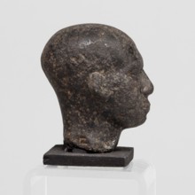 Head of a priest figurine, A man's head, fragment of a statuette, completely devoid of hair. Skull