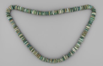 Necklace of disc-shaped beads. Long necklace consisting of flat, disc-shaped beads thicker in the