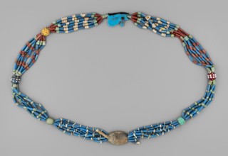 Necklace with a scarab and an udjat eye. Necklace composed of six rows of faience tubular and