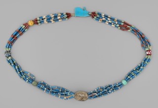 Necklace with a scarab and an udjat eye. Necklace composed of six rows of faience tubular and