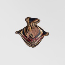 Amulet in the shape of a heart ib, made of black and brown glass decorated with parallel lines