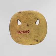 Amulet — plaque with the head of the god Bes. Amulet in the form of an oval, serrated, openwork