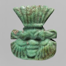 Amulet — plaque with the head of the god Bes;, Amulet in the form of a plaque with a relief