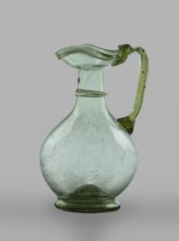 Oinochoe, Transparent, light green glass. Spherical belly on a foot with a clearance, created by