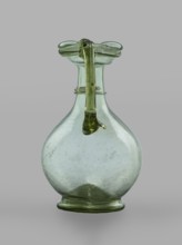 Oinochoe, Transparent, light green glass. Spherical belly on a foot with a clearance, created by
