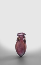 Amphora, unknown eastern workshop; translucent manganese glass; elongated ovoid body covered with