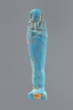 Ushabti, Mummy-shaped figurine, standing on a base, back supported by a pillar/pilaster. Arms
