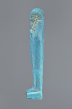 Ushabti, mummy-shaped figurine standing on a base, back supported by a pillar/pilaster. Arms