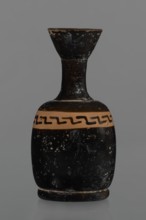 Black-finned aryballois lekythos. Large, ring-shaped foot. Body squat, barrel-shaped with rounded