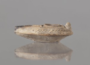 Oil lamp, unknown Palestinian workshop. Oval lamp with conical handle. Large olive opening