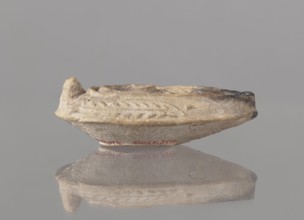 Oil lamp, unknown Palestinian workshop. Oval lamp with conical handle. Large olive opening