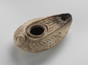 Oil lamp, unknown Palestinian workshop. Oval lamp with conical handle. Large olive opening