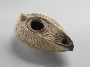 Oil lamp, unknown Palestinian workshop. Oval lamp with conical handle. Large olive opening