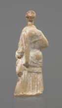 Terracotta figurine of a standing woman. Terracotta, molded figurine; 4th century BC, Tanagra