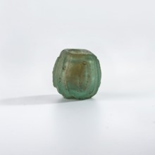 Bottle, Islamic, Persian; blue-green glass bottle decorated with small almond-shaped ovals in an