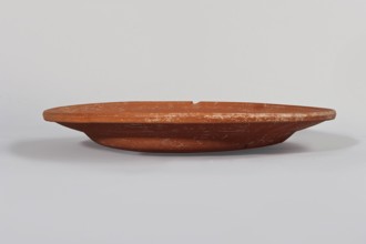 Terra sigillata plate. Flat plate with a very low foot and a rather flat, wide rim. Made of clay