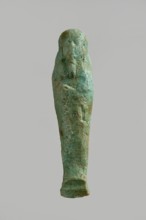 Ushabti figurine, very schematically designed. Distinct narrow beard, tools in crossed hands. Flat