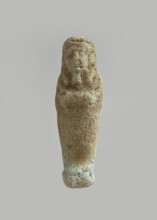Ushabti. Carelessly made figurine with schematic facial features, in a narrow wig revealing the